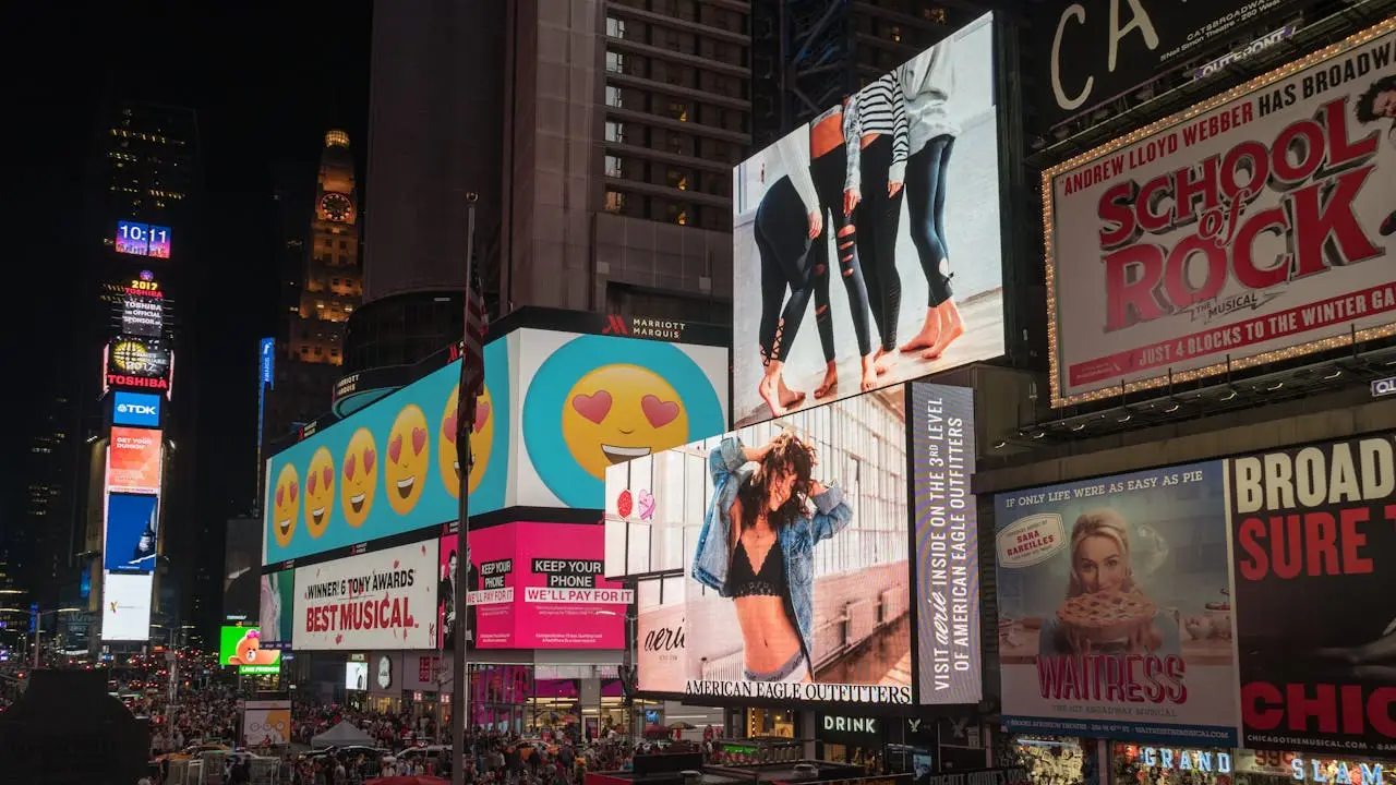 services-02 Colorful billboards light up New York Citys iconic Times Square at night, with vibrant ads and bustling crowds.