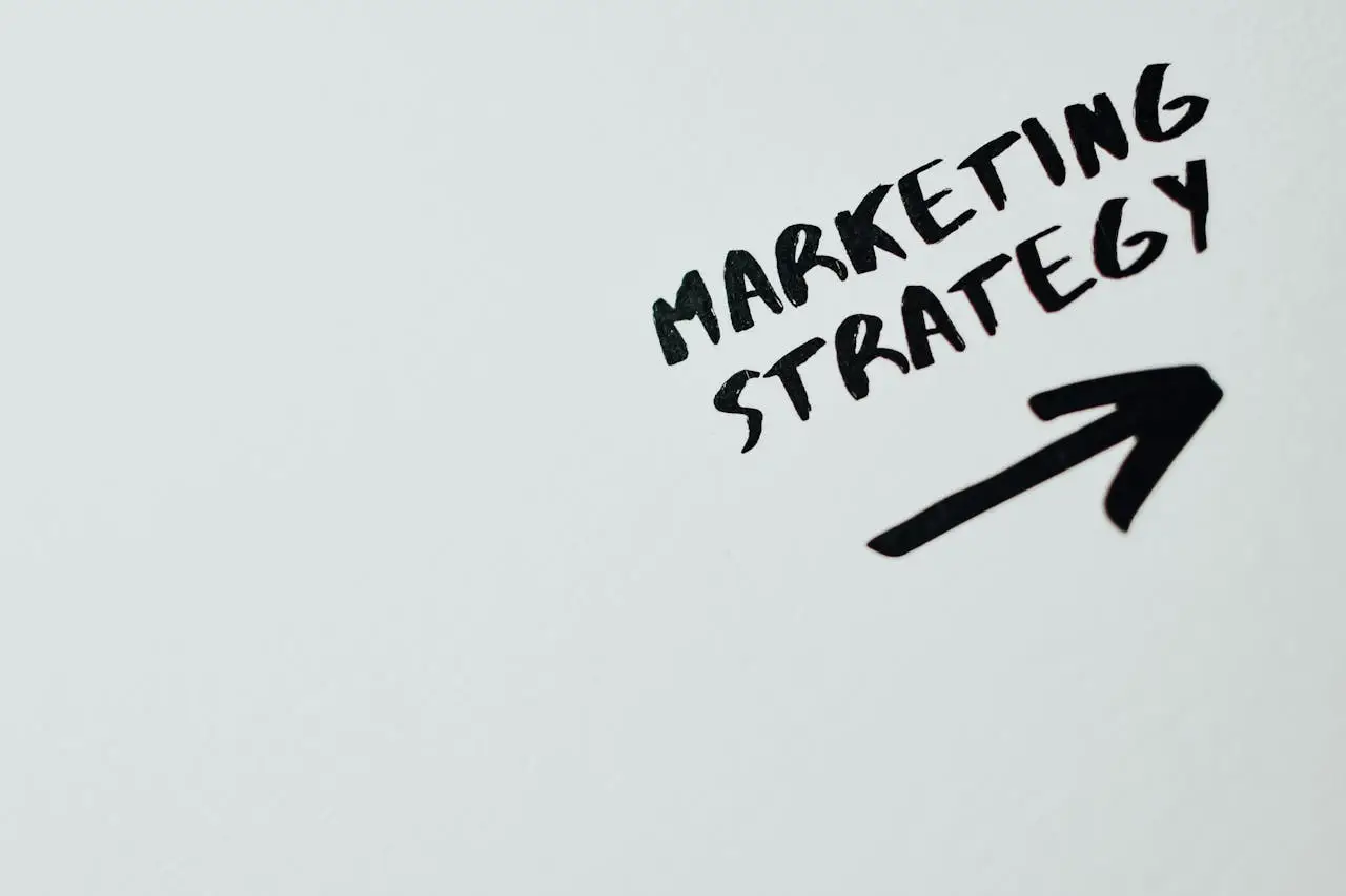 services-hero Close-up of handwritten Marketing Strategy text with an arrow on white background.